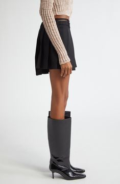 The Stockholm-based label blends the polish of classic suiting with schoolcore charm in this sharply knife-pleated miniskirt lightly kissed with wool. A slender belt designed to lay slightly above the skirt's waistband pays homage to the low-slung silhouettes of Y2K, while an asymmetric hemline furthers the statement-making aesthetic. Removable belt Unlined 55% polyester, 45% wool Dry clean Made in Portugal Designer Clothing Fall Workwear Mini Pleated Skirt, Fall Pleated Mini Skirt For Workwear, Classic Mini Pleated Skirt For Work, Fall Workwear Skort With Pleated Hem, Pleated Hem Skort For Workwear In Fall, Fall Office Mini Pleated Skirt, Classic Workwear Mini Skirt With Pleated Hem, Classic Mini Skirt With Pleated Hem For Work, Classic Mini Skirt With Accordion Pleats