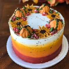 a cake decorated with sunflowers and leaves