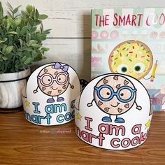 two paper hats with the words i am a smart cook and donut on them