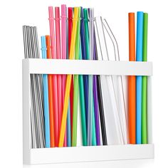 a white book shelf filled with lots of different colored straws