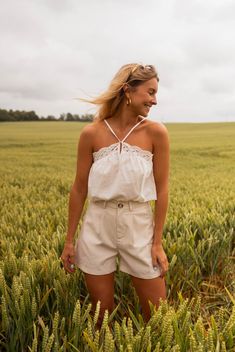 Our white embroidered halter neck top features adjustable straps, a lightweight design, and a slightly flared silhouette. It is also slightly sheer, adding an alluring touch to your look. Our model wears the beige Adela shorts Sizes: S/M/L S: Length 22 in - Width 16.4 in M: Length 22.8 in - Width 17.7 in L: Length 23.6 in - Width 18.9 in 100% Cotton Washing: 86 F European Women, Halter Neck Top, Women's Summer Fashion, Halter Neck, Summer Women, Best Sellers, North America, Adjustable Straps, Summer Fashion