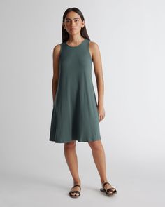 This mini swing dress is as flattering as it is flirty. Made with our soft Tencel™ fabric, the relaxed fit and flared hem creates a silhouette that flatters every form. Tencel™ lyocell is a biodegradable fabric made from cellulose found in wood pulp. It is softer, more breathable, and uses 10-20 times less water in production compared to cotton.  | Quince | Women's Tencel Jersey Mini Swing Dress in Dark Olive, Size XS Cashmere Robe, Blonde With Blue Eyes, Travel Dress, Maxi Tank Dress, Quince, Jersey Dress, Swing Dress, Dress Skirt, Nice Dresses