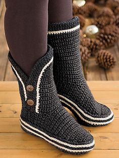 a woman's legs wearing black and white knitted boots