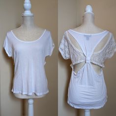 By One Step Up, Size Large All White Tee Material And White Lace. Back Has A Horizontal Lace Panel Which Transitions To Sleeves. The Back Tee Shirt Material Forms Racer-Back Over The Lace And Has A Knot Cinching The Middle In. About A 36 Inch Bust And 22 Inches From Shoulder To Bottom Hem. New Without Tags, Never Worn. Comes From A Smoke Free Home. Short Sleeve Stretch Lace Top, Spring Daywear Tops With Scoop Neck, Stretch Crew Neck Top For Daywear, Scoop Neck Spring Tops For Daywear, Scoop Neck Tops For Spring Daywear, Scoop Neck Stretch Top For Daywear, Stretch Scoop Neck Top For Daywear, Casual Scoop Neck Tops For Daywear, Stretch Lace Top For Day Out