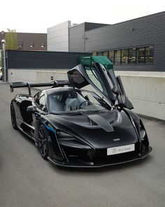 a black sports car parked in front of a building