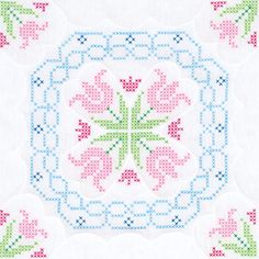 a cross - stitched square with flowers and leaves in the center, on a white background