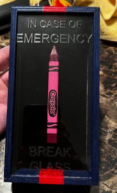 there is a pink crayon sign with the words in case of emergency on it