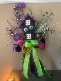 a black and green decoration with eyes on it