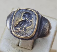 Ring Owl- Ancient Bronze  Vintage-Antique ROMAN RARE -N -19us. 19mm.                                                                        Made in Europe Self designed bronze ring in original Roman style. Rare antique bronze artifact look.  The articles are handcrafted using high quality materials.  The technology used in making the ring does not differ from the original method in Bizantian - Roman times. Size: 19 mm. N-9 5 us. Material: Masive Real Bronze.  If you want express delivery with DH Luxury Antique Bronze Rings, Vintage Antique Silver Signet Ring Gift, Antique Bronze Hand Cast Ring, Vintage Bronze Hand Cast Ring, Vintage Hand Cast Bronze Ring, Antique Engraved Silver Ring, Vintage Hand Cast Engraved Round Ring, Hand-cast Vintage Engraved Ring, Antique Oxidized Finish Engraved Ring As Gift