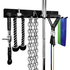 an assortment of tools hanging from a rack with chains and hooks attached to the wall