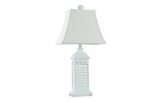 a white table lamp with a white shade on the top and bottom part of it