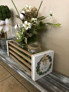 a wooden crate filled with flowers on top of a table