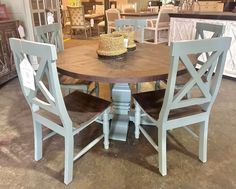 a wooden table with chairs around it in a store