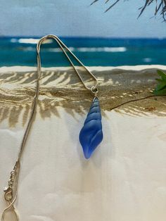 cobalt blue sea glass shell Blue Wire Wrapped Necklace For Beach, Ocean-inspired Blue Shell Necklace As A Gift, Beach Necklace In Sea Blue, Ocean-inspired Blue Shell Necklace As Gift, Ocean-inspired Blue Shell Necklace Gift, Blue Recycled Glass Jewelry With Ocean-inspired Style, Elegant Blue Sea Glass Jewelry, Blue Ocean-inspired Recycled Glass Jewelry, Blue Shell-shaped Ocean-inspired Necklace