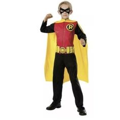 a boy in a costume that is wearing a red and yellow cape with black lettering on it