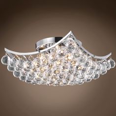 a modern ceiling light with crystal balls on it's sides and an elegant design