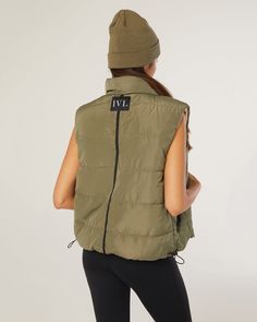 Featuring a high neck for extra insulation, this zip-front reversible puffer vest can be worn on either the faux leather or Taslon polyester sides. High-neck Zip-front reversible puffer vest Wearable on faux leather or Taslon polyester sides 100% Polyester The Reversible Puffer Vest is styled with the Cami Jumpsuit and the Knit Beanie. Winter Nylon Vest With Zipper Closure, Nylon Vest With Zipper Closure For Winter, Padded Collar Vest For Cold Weather In Fall, Fall Cold Weather Vest With Padded Collar, Fall Vest With Padded Collar For Cold Weather, Sporty Winter Vest For Layering, Outdoor Fall Vest With Padded Collar, Fall Outdoor Vest With Padded Collar, Fall Nylon Vest For Layering