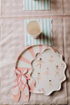 the table is set with ballet themed plates and napkins