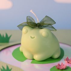 there is a small green cake with a bow on it