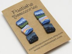 pair of earrings with mountains in the background on card board for sale at www positinegreessories com