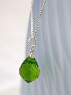 "SHIPPING - Please note that this item will ship from Canada. - Handmade by me - 7.5 Carat Peridot ( lab made gem) 14mm x 10mm - Solid Sterling Silver - Sterling Box Style Chain from Italy 18\" or 20\" Pendant is 23mm / just under 1\" long measured from top of bale. August birthstone 16th anniversary gem I've wire wrapped this lovely gem in sterling silver wire. The gem is a gorgeous bright green color that reminds me of Spring.  This will come in a pretty organza bag. Thank you for looking:) Es Jewelry Sets Handmade, 16th Anniversary, Gem Pendant, Rhinestone Jewelry Set, Parrot Green, Hemp Jewelry, Peridot Pendant, August Birthstone, Green Peridot