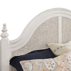 a white headboard with blue and orange pillows on it's sides, against a white background