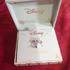 the disney necklace is in its box and it has an elephant charm attached to it