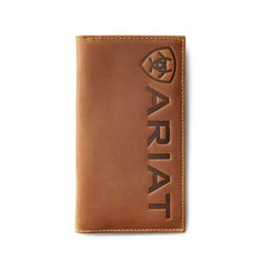 This rugged, rodeo-style wallet makes it easy to stay organized. Featuring distinctive, debossed logo detailing, it neatly stores your credit cards, cash and ID. \r\n\r\nRodeo style wallet with debossed Ariat detailing\r\nCredit card slots\r\nClear ID window\r\nRemovable photo slip\r\nCash compartment\r\nMeasures: 6 1/2 x 3 1/2\r\n\r\nRodeo Wallet Large Logo | Men's Rodeo Wallet Large Logo in Medium Brown, Size: OS by Ariat Western Wallets, Rodeo Style, Vertical Logo, Rodeo Fashion, Debossed Logo, Shield Logo, Logo Sign, Stay Organized, Medium Brown