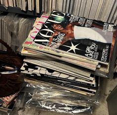 a stack of magazines sitting on top of each other in front of a metal rack