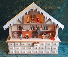 a doll house with lots of furniture and decorations on the top shelf in front of it