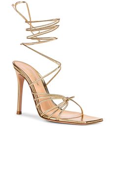 Find GIANVITO ROSSI Nappa Silk Strappy Heels In Metallic Gold on Editorialist. Gianvito Rossi Nappa Silk Strappy Heels in Metallic Gold Metallic leather upper with leather sole. Made in Italy. Wrap around ankle strap with tie closure. Square toe. Strappy design. Approx 100mm/ 4 inch heel. GIAN-WZ537. G32016-15RIC-NPS. About the designer: With footwear in his blood-his father Sergio contributedto the history of Italian footwear worldwide-Gianvito Rossi designs shoes, first and foremost, to accentuate a womans silhouette in a harmonious combination of proportion and graceful lines. A love for beauty, aesthetics and harmony of proportions guides the stylist in each of his creations, which are pure forms of design, far from excess and exaggeration and true to the never-shouted elegance thathas Luxury Heels With Heel Strap And Ankle Wrap, Luxury Ankle Wrap Heels With Heel Strap, Luxury Ankle Wrap Heels For Formal Occasions, Designer Gold Heels With Wrapped Heel, Luxury Ankle Wrap Heels With Wrapped Heel, Luxury Wrapped Heel Ankle Wrap Heels, Chic Gold Ankle Wrap Heels, Gold Chic Ankle-wrap Heels, Designer Heels With Wrapped Heel For Events