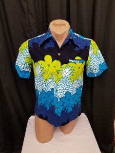 Vintage 1970's Aloha by Sears Hawaii Bright Blue Green White Floral Pineapple Print Thick Cotton Short Sleeve Hawaiian Button Shirt, 42 Chest.  Shirt features a 4 gold detailed button closure down the front, 1 left chest pocket, and a winged collar. Shirt is in Excellent vintage condition -  see pics Measurements: shoulder to shoulder 16 1/2 in, chest 42 in, waist 40, sleeves shoulder to cuff 9, sleeves pit to cuff 5, back of neck to waist length 26 in. Retro Hawaiian Shirt With Button Closure For Summer, Vintage Green Camp Shirt For Beach, Vintage Green Camp Shirt For The Beach, Retro Blue Cotton Hawaiian Shirt, Retro Button-up Hawaiian Shirt, Retro Hawaiian Shirt For Beach With Button Closure, Retro Hawaiian Shirt For The Beach, Vintage Blue Beach Shirt, Retro Blue Printed Camp Shirt