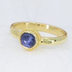 This beautiful 18K Treasure Gold ring, crafted with sunken treasure, showcases a majestic 0.83ct rose-cut blue sapphire. Enjoy the delightful shimmer of its water-ripple band, while its ancient feel adds a touch of mystery to any outfit. While I can make similar style rings, this one is one-of-a-kind owing to the irregular cut of the gem. Handcrafted in solid 18K gold made with 400 year-old sunken treasure recovered from the Caribbean. Size 7.25, but each ring comes with free sizing and FREE SHI Handmade Yellow Gold Sapphire Ring, Gold Hand Forged Sapphire Ring, Hand Forged Gold Sapphire Ring, Hand Forged Blue Sapphire Ring For Anniversary, Hand Forged Blue Sapphire Ring Gift, Anniversary Blue Hand Forged Sapphire Ring, Treasure Gold, Sunken Treasure, Blue Sapphire Ring