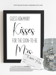 a glass jar filled with candy next to a sign that says guess how many kisses for the soon - to - be mrs