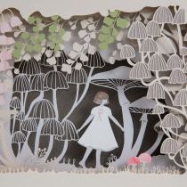 paper cut artwork depicting a woman in white dress and trees with pink flowers on them