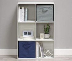 a white book shelf filled with lots of books and other items on top of it