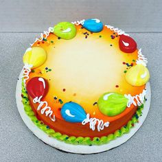 a birthday cake decorated with colorful candies and icing