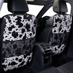 the interior of a car with black and white spots on it's seat covers