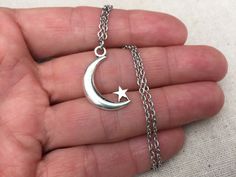 "Mysterious and magical moon and star pendant necklace. Eloquently cut showcasing an eye catching night inspired silhouette. A very thoughtful piece of jewelry. The pendant is made from allergy free plated silver. It measures 1\" long by 1/2\" wide and hangs from an 18\" stainless steel necklace. I have matching earrings in my shop. Here is the link https://etsy.me/2Pws39G Thanks for stopping by! Please take a moment and visit the rest of my Etsy shop. I have many more unique jewelry designs to Magical Star-shaped Jewelry For Gifts, Magical Star-shaped Jewelry Gift, Mystical Jewelry With Star Charm For Gifts, Mystical Star Charm Jewelry For Gift, Mystical Star Charm Jewelry Gift, Silver Crescent Charm Necklace With Star, Mystical Star-shaped Jewelry With Moon Charm, Mystical Star-shaped Necklace For Gift, Mystical Star-shaped Jewelry Gift