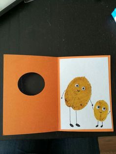 an open book with pictures of two yellow birds on it and a hole in the middle