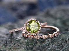 a yellow diamond ring sitting on top of a rock