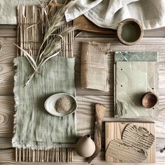 a table topped with lots of different items on top of a wooden floor covered in white cloth