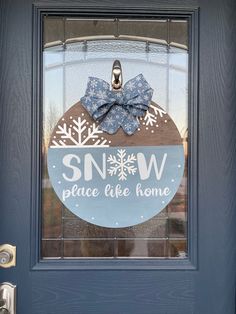 a blue door with a snow place like home sign on the front and side glass