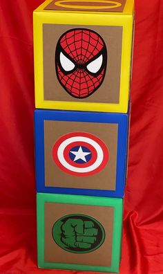 a cardboard box that has some pictures on it and the words spiderman painted on it