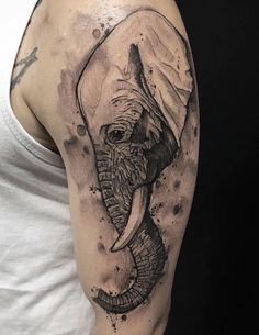 an elephant tattoo on the arm and shoulder