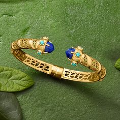 Ross-Simons - Lapis and Turquoise Cuff Bracelet in 18kt Gold Over Sterling. 8". A unique design comprised of classically luxurious elements, this cuff bracelet features gorgeous openwork detailing capped with 8mm round lapis and 3mm round stabilized turquoise cabochon decor. Crafted in textured and polished 18kt yellow gold over sterling silver with milgrain detailing. Natural pyrite flecks in lapis may vary. Hinged. Slip-on, turquoise and lapis cuff bracelet. Luxury Blue Cuff Bracelet, Luxury Blue Gemstone Bangle, Luxury Yellow Gold Cuff Bracelet With Gemstone, Luxury Turquoise Bangle Bracelets, Elegant Turquoise Cuff Bracelet With Gemstone, Luxury Cuff Bracelet Bangle With Gemstone Accents, Elegant Turquoise Bangle For Formal Occasions, Elegant Cuff Bracelet With Gemstone Accents, Elegant Turquoise Bangle For Wedding