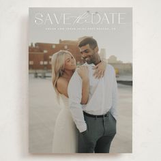 a magazine cover with an image of a man and woman hugging each other in front of a cityscape