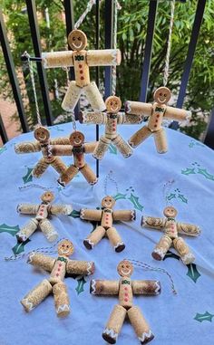 a table topped with lots of different types of gingerbreads on top of a blue cloth covered tablecloth