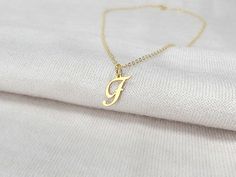 "A dainty initial letter necklace with any letter cut out. You can choose the length of your necklace and the type of metal you would like it made out of. The metal options are silver, gold or rose gold. The initial pendant is about 15 mm tall, so it is very dainty and cute! It makes the perfect everyday necklace.  DETAILS Metal: Silver, Gold or Rose Gold Chain: 16\", 18\", 20\" PROCESS 1. Choose your metal and chain length in the drop down menu 2. Write the initial or initials you would like for your order in the personalization box 3. Place your order 4. Ships out in 1-2 business days! Please reach out with any questions you may have! See our shop for many more designs! https://www.etsy.com/shop/SincerelySilverShop" F Initial, Letter Necklace Gold, Gold Letter Necklace, Initial Pendant Necklace, Rose Gold Chain, Everyday Necklace, Necklace Dainty, Initial Letter, Initial Pendant