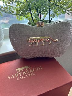 Elevate your style with our Sabyasachi-inspired premium clutch, a true embodiment of luxury and elegance. This exquisite clutch is designed to complement any outfit, making it perfect for weddings, parties, and special occasions. Crafted with meticulous attention to detail, it combines traditional aesthetics with contemporary design, ensuring you stand out wherever you go. Shipped in a designer box with Sabya Logo Product Features: Design: Inspired by the iconic Sabyasachi style Quality: Premium craftsmanship and materials Detailing: Intricate embroidery/beading with exquisite finish Closure: Secure clasp closure Interior: Spacious and cloth lined with designer stamping inside as well can fit iPhone inside, even ProMax Chain included Versatile: Perfect for weddings, parties, festive celebr Luxury Leather Box Bag For Evening, Sabyasachi Logo Design, Luxury Shoulder Bag With Dust Bag For Wedding, Luxury Traditional Wedding Clutch, Luxury Elegant Square Pouch, Luxury Classic Clutch With Fold Over Clasp, Luxury Elegant Embroidered Clutch, Luxury Formal Pouch With Zipper Closure, Luxury Pouch Bag For Reception